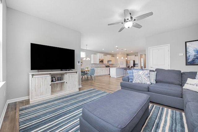 living room with recessed lighting, baseboards, ceiling fan, and light wood finished floors