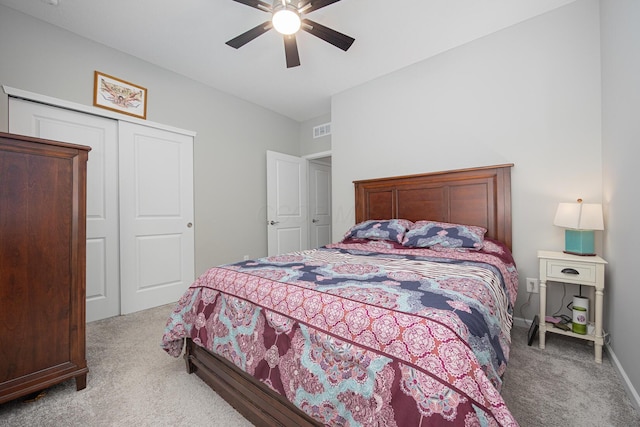 carpeted bedroom featuring baseboards, ceiling fan, a closet, and visible vents