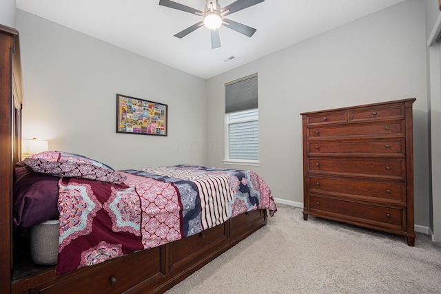 bedroom featuring baseboards, light carpet, a ceiling fan, and visible vents