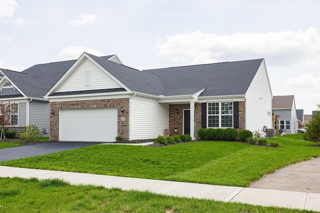 view of front of property with brick siding, an attached garage, driveway, and a front lawn
