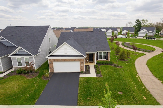 view of front of home featuring a residential view, an attached garage, a front lawn, brick siding, and aphalt driveway
