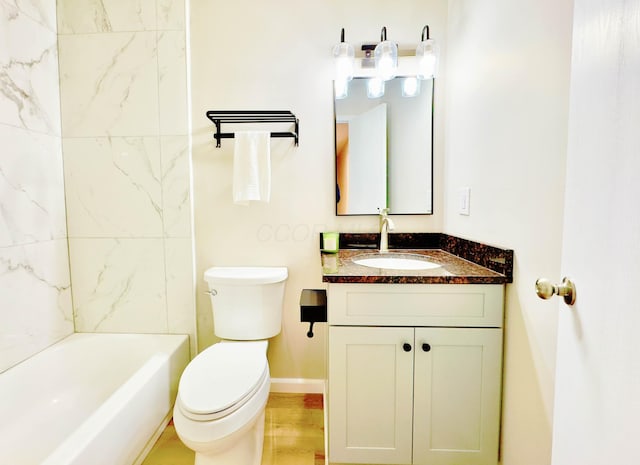 bathroom with vanity, baseboards, toilet, and shower / bathing tub combination