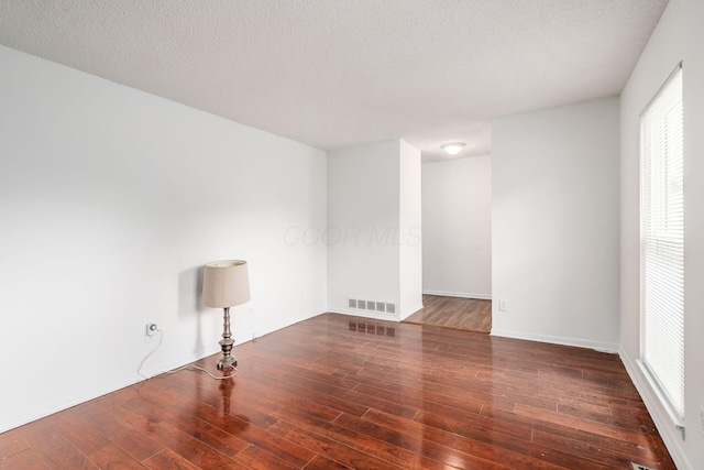 6556 Centennial Dr, Reynoldsburg, OH 43068 - empty room featuring plenty of natural light, visible vents, baseboards, and wood-type flooring