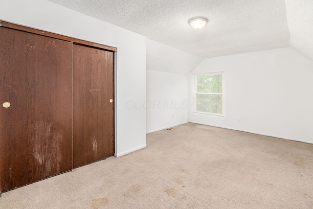 6556 Centennial Dr, Reynoldsburg, OH 43068 - bonus room featuring baseboards, carpet flooring, a textured ceiling, and vaulted ceiling