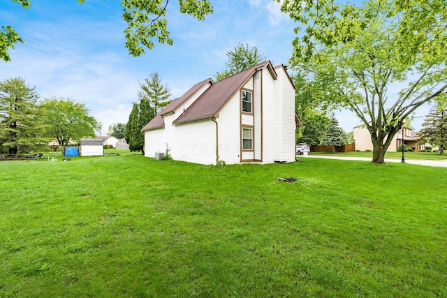 6556 Centennial Dr, Reynoldsburg, OH 43068 - view of side of property featuring a yard, stucco siding, and central AC unit
