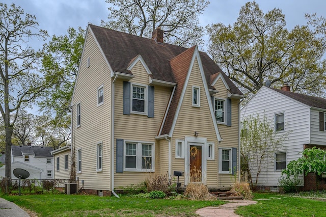 2513 Georgetown Ave, Toledo, OH 43613 - view of front of home with central air condition unit, a chimney, a shingled roof, and a front yard
