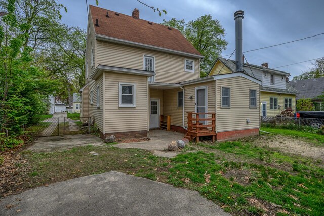 2513 Georgetown Ave, Toledo, OH 43613 - rear view of house with a gate and fence
