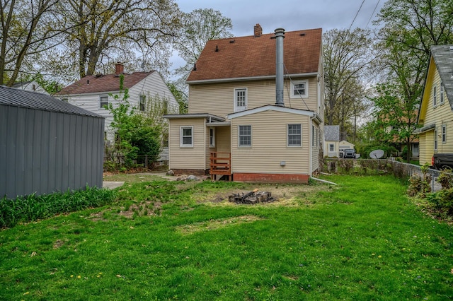 2513 Georgetown Ave, Toledo, OH 43613 - rear view of property with a lawn, fence, and a chimney