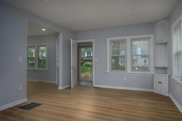 2513 Georgetown Ave, Toledo, OH 43613 - unfurnished dining area featuring visible vents, light wood finished floors, and a wealth of natural light