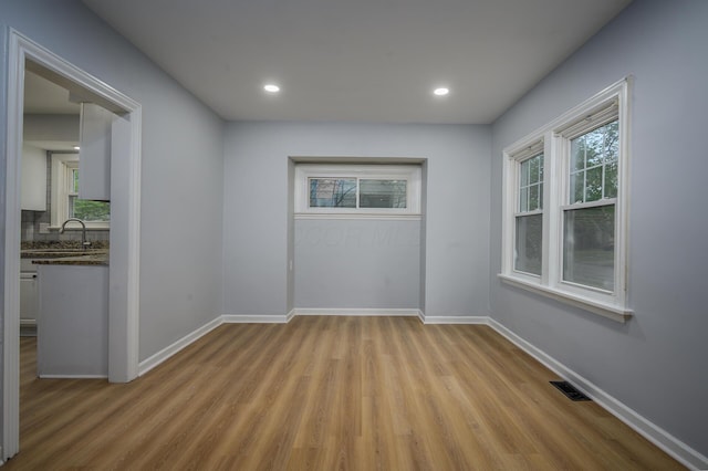 2513 Georgetown Ave, Toledo, OH 43613 - spare room featuring baseboards, visible vents, a sink, and light wood-style floors