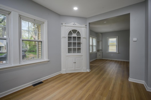 2513 Georgetown Ave, Toledo, OH 43613 - unfurnished dining area featuring baseboards, a wealth of natural light, wood finished floors, and visible vents