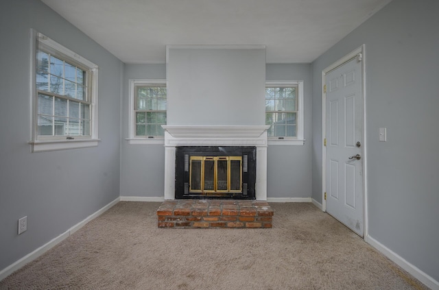 2513 Georgetown Ave, Toledo, OH 43613 - unfurnished living room featuring baseboards, carpet, and a brick fireplace