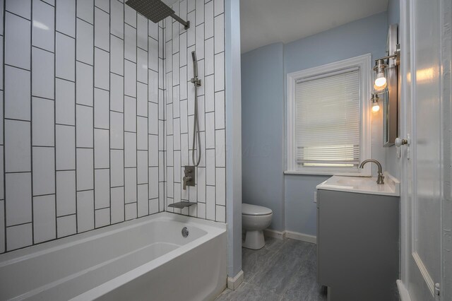 2513 Georgetown Ave, Toledo, OH 43613 - bathroom featuring vanity, baseboards, bathing tub / shower combination, and toilet