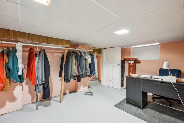office area featuring finished concrete floors and a drop ceiling