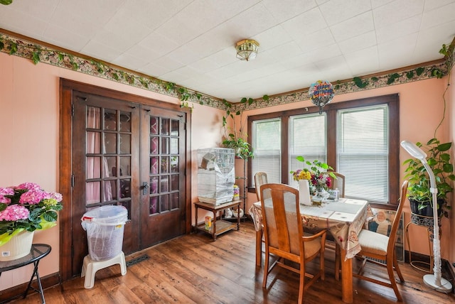 dining space with french doors and hardwood / wood-style floors
