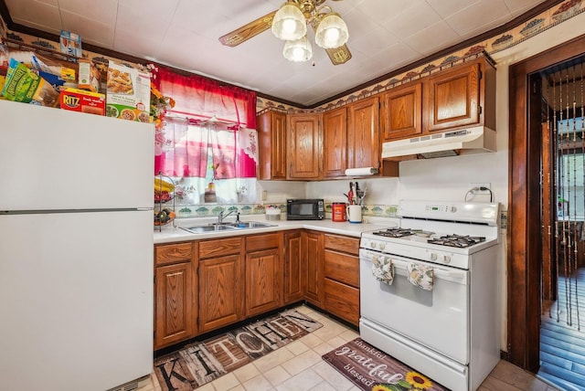 kitchen featuring a ceiling fan, white appliances, light countertops, under cabinet range hood, and a sink