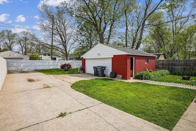 detached garage featuring a gate and fence