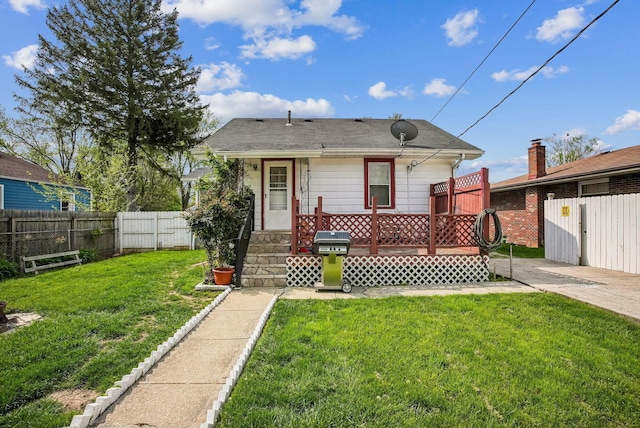 exterior space with fence private yard, a front lawn, and a deck