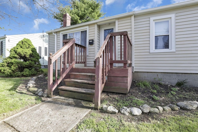 entrance to property featuring a chimney