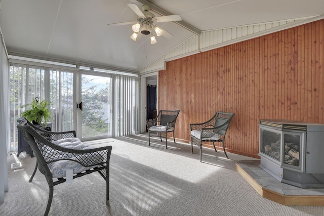 sunroom / solarium featuring a healthy amount of sunlight, a ceiling fan, and beam ceiling