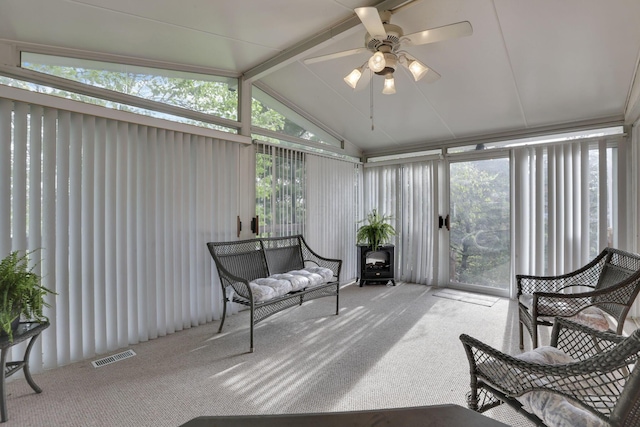 sunroom / solarium with ceiling fan, visible vents, and beam ceiling