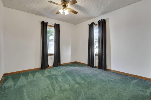 spare room with baseboards, a textured ceiling, carpet flooring, and ceiling fan