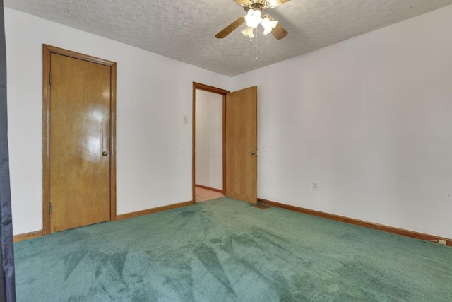 unfurnished bedroom with carpet floors, a textured ceiling, ceiling fan, and baseboards