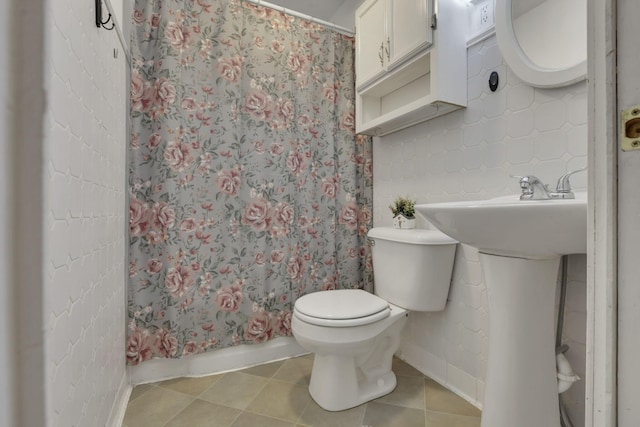 bathroom with tile patterned floors and toilet