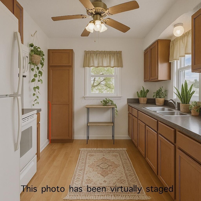 119 Highland Ave, Circleville, OH 43113 - kitchen featuring white appliances, dark countertops, plenty of natural light, and light wood-style floors