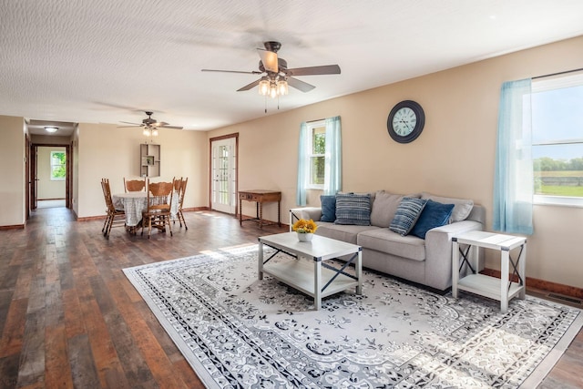 14140 State Route 56 SE, Mount Sterling, OH 43143 - living area featuring dark wood-style flooring, a ceiling fan, baseboards, and healthy amount of natural light