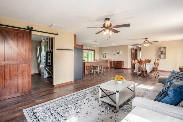 14140 State Route 56 SE, Mount Sterling, OH 43143 - living room with a barn door, dark wood-style floors, ceiling fan, and baseboards