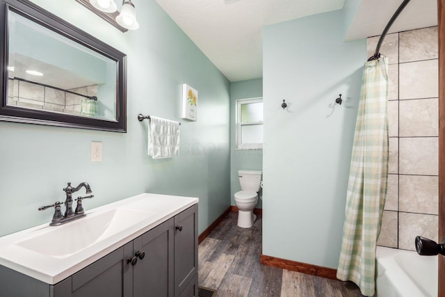 14140 State Route 56 SE, Mount Sterling, OH 43143 - full bathroom featuring wood finished floors, vanity, toilet, shower / tub combo, and baseboards