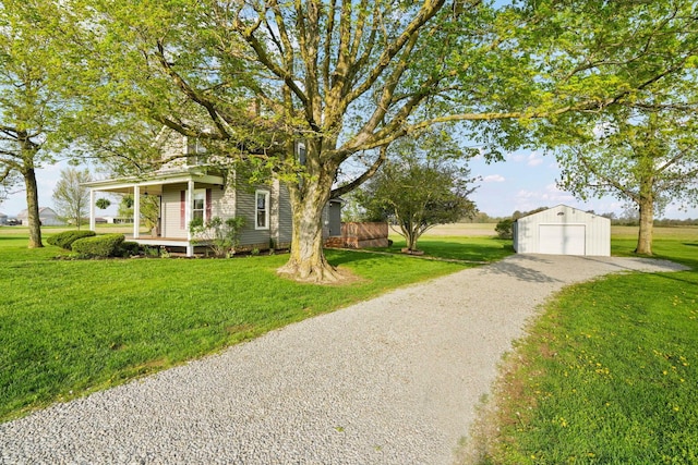 view of front of home featuring an outdoor structure, a garage, driveway, and a front yard