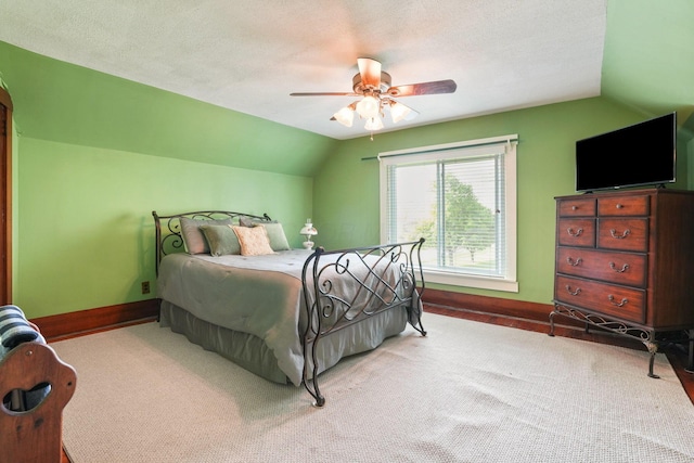 bedroom with carpet flooring, baseboards, vaulted ceiling, and ceiling fan