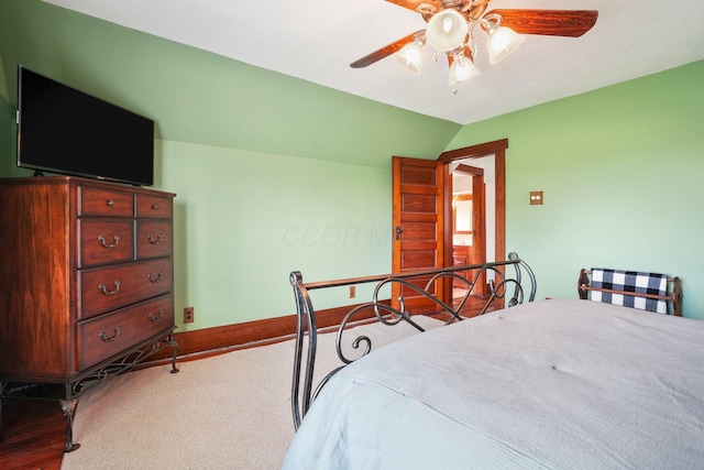 bedroom featuring a ceiling fan, baseboards, and vaulted ceiling