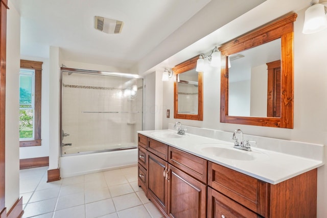 full bath featuring double vanity, visible vents, a sink, and tile patterned flooring