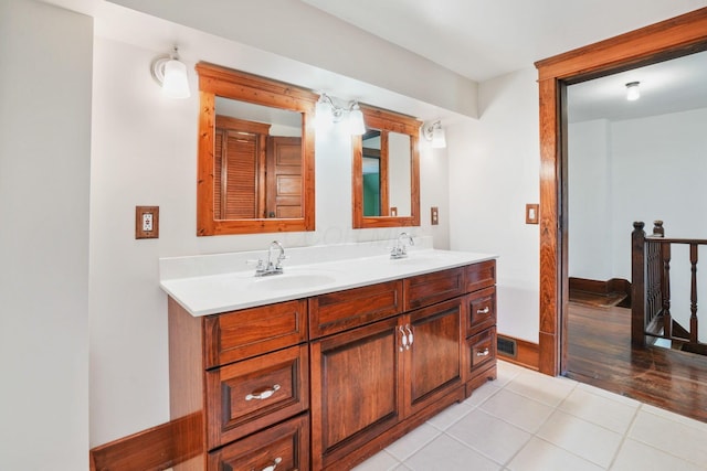 bathroom featuring double vanity, tile patterned floors, and a sink