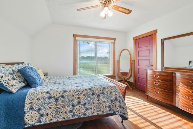 bedroom featuring a ceiling fan, vaulted ceiling, and wood finished floors