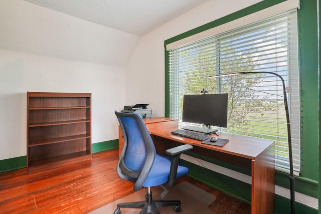 office featuring wood finished floors, baseboards, and lofted ceiling