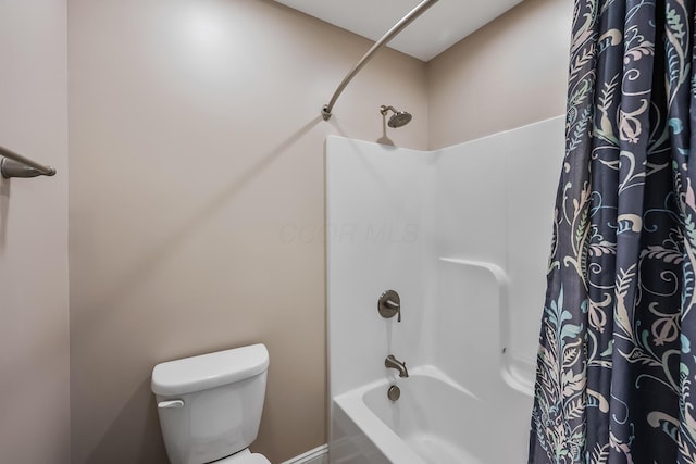 full bathroom featuring toilet and shower / bath combination with curtain