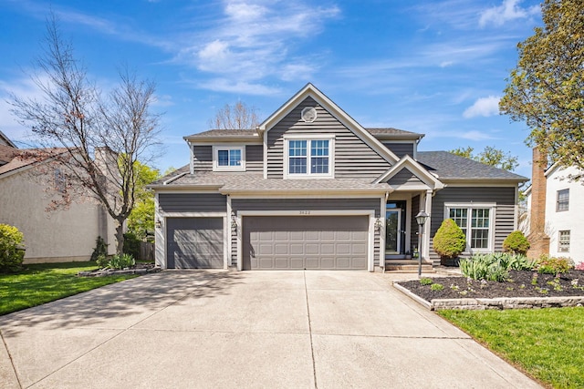 3622 Boathouse Dr, Hilliard, OH 43026 - view of front of house featuring a garage, a shingled roof, and concrete driveway