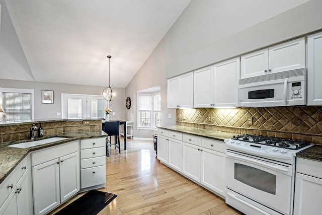 3622 Boathouse Dr, Hilliard, OH 43026 - kitchen featuring white appliances, backsplash, white cabinets, and a sink