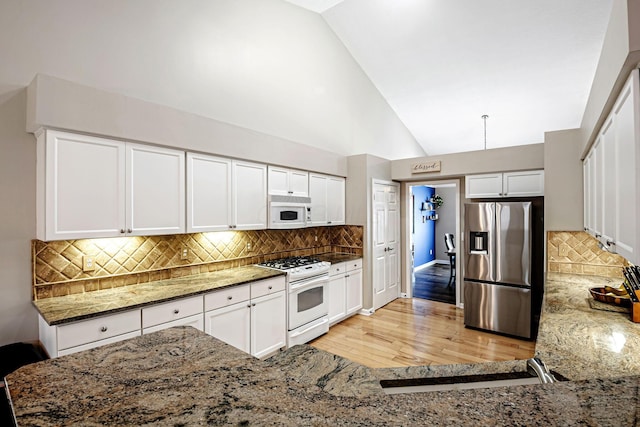 3622 Boathouse Dr, Hilliard, OH 43026 - kitchen with tasteful backsplash, white appliances, white cabinetry, stone counters, and light wood-type flooring