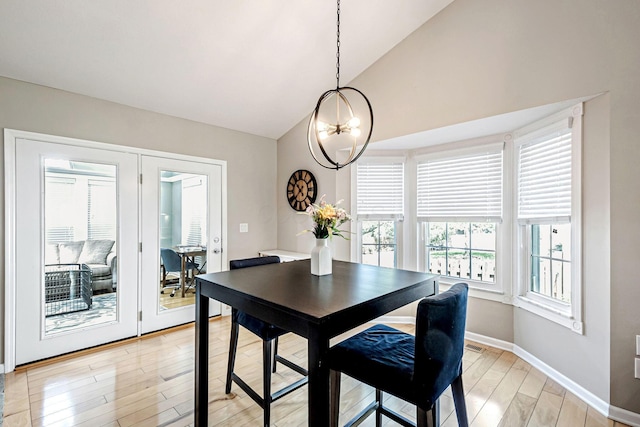 3622 Boathouse Dr, Hilliard, OH 43026 - dining room featuring light wood-style floors, baseboards, high vaulted ceiling, and a notable chandelier