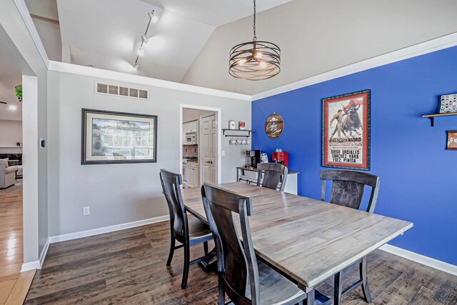 3622 Boathouse Dr, Hilliard, OH 43026 - dining room featuring visible vents, lofted ceiling, wood finished floors, baseboards, and a chandelier