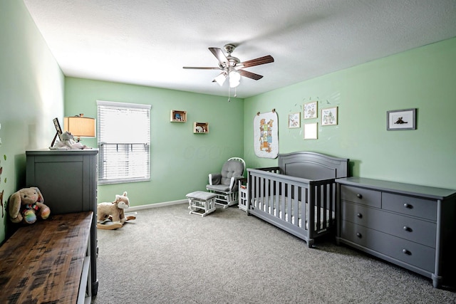 3622 Boathouse Dr, Hilliard, OH 43026 - bedroom with a crib, a textured ceiling, carpet, a ceiling fan, and baseboards