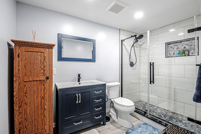 3622 Boathouse Dr, Hilliard, OH 43026 - bathroom with vanity, toilet, wood finished floors, visible vents, and a stall shower