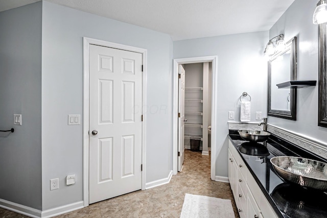 3622 Boathouse Dr, Hilliard, OH 43026 - bathroom featuring baseboards, double vanity, a sink, and a spacious closet