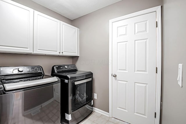 3622 Boathouse Dr, Hilliard, OH 43026 - laundry area featuring separate washer and dryer, baseboards, light tile patterned flooring, and cabinet space