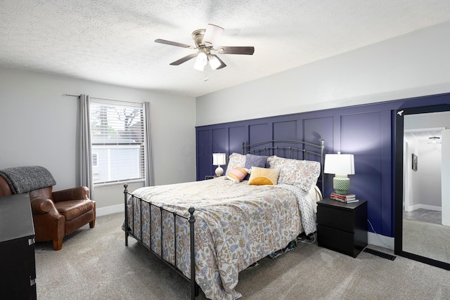 5756 Idana Ct, Westerville, OH 43081 - carpeted bedroom with ceiling fan, a textured ceiling, and a decorative wall
